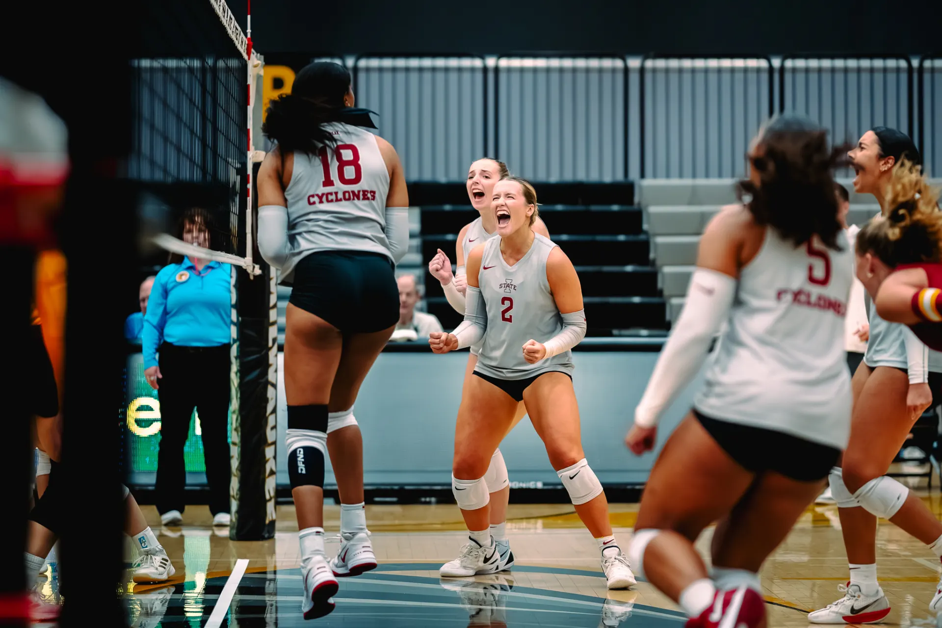 Volleyball players celebrating a point on court