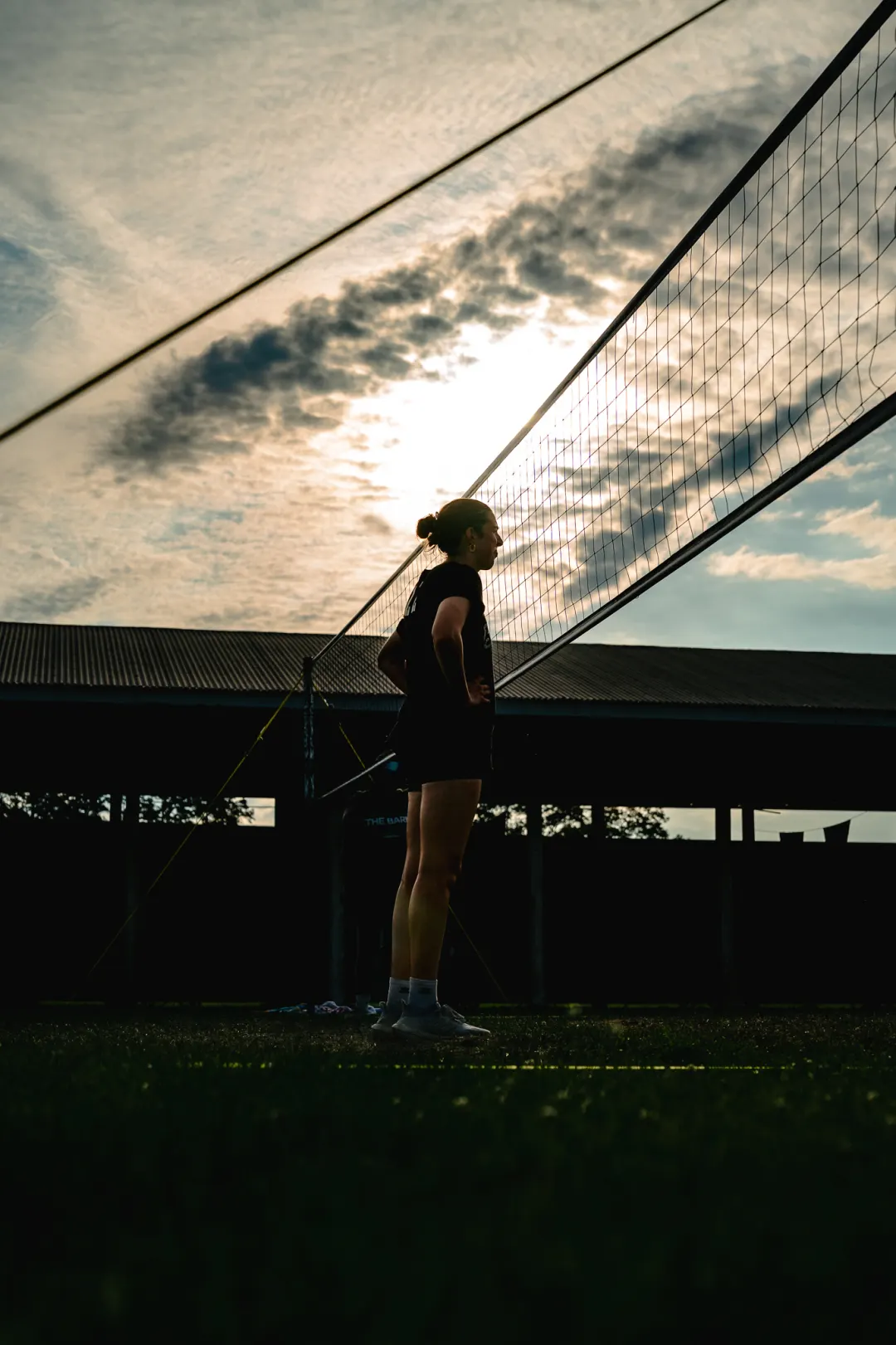 Volleyball player silhouetted against an evening sky