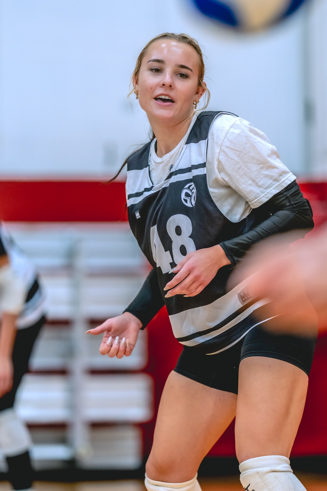 A player in a black and white jersey moves on the court.