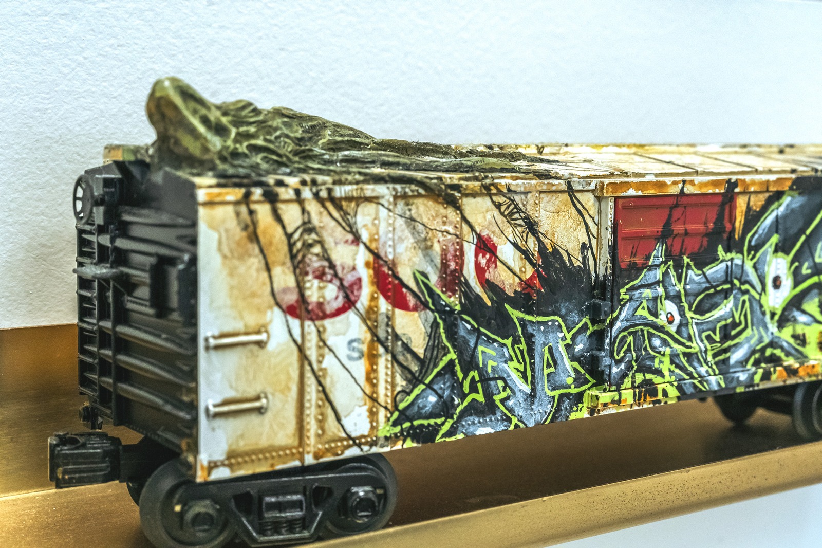 A model train car with graffiti art.
