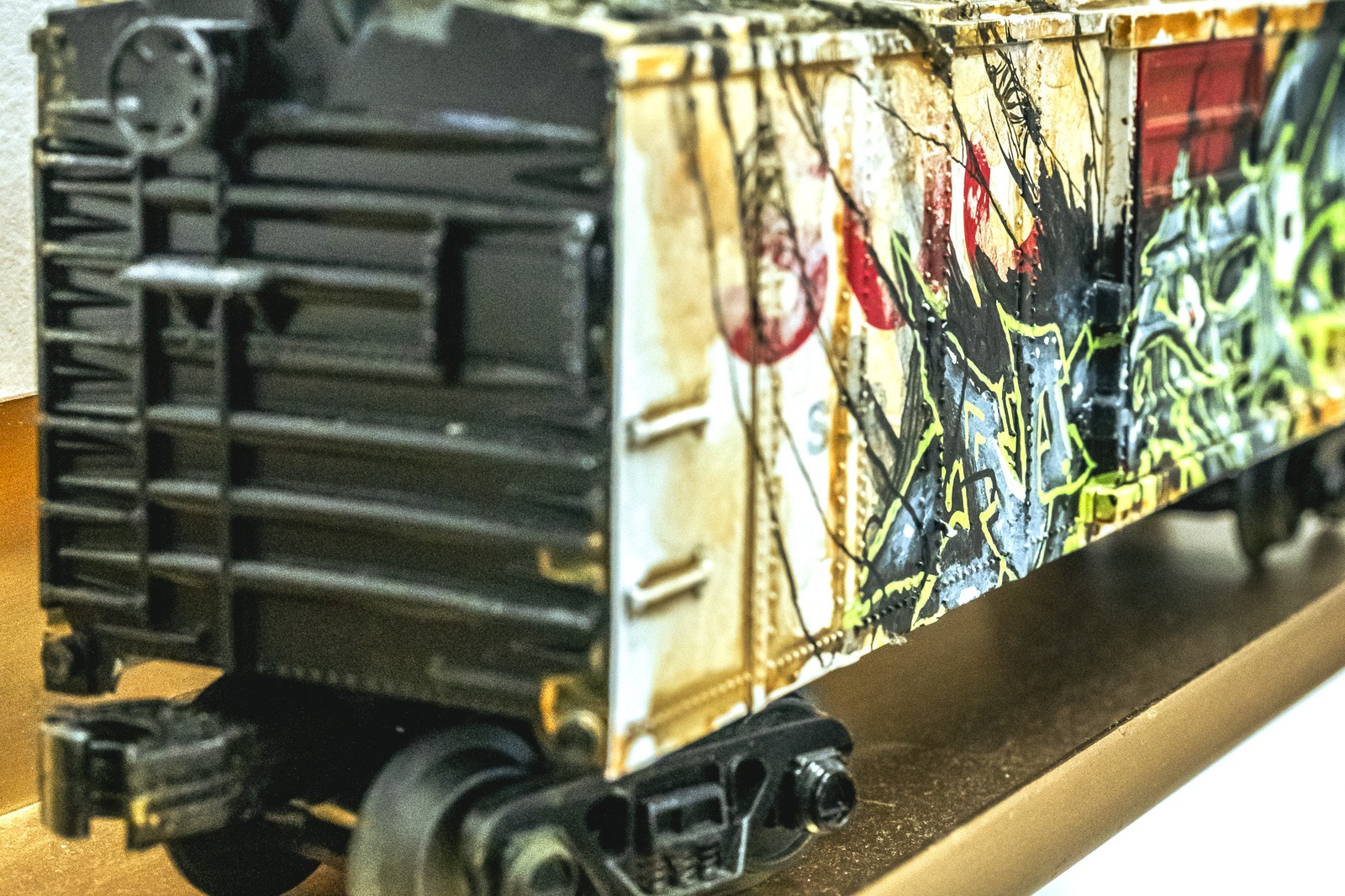 A graffiti-covered train car sits on a track.