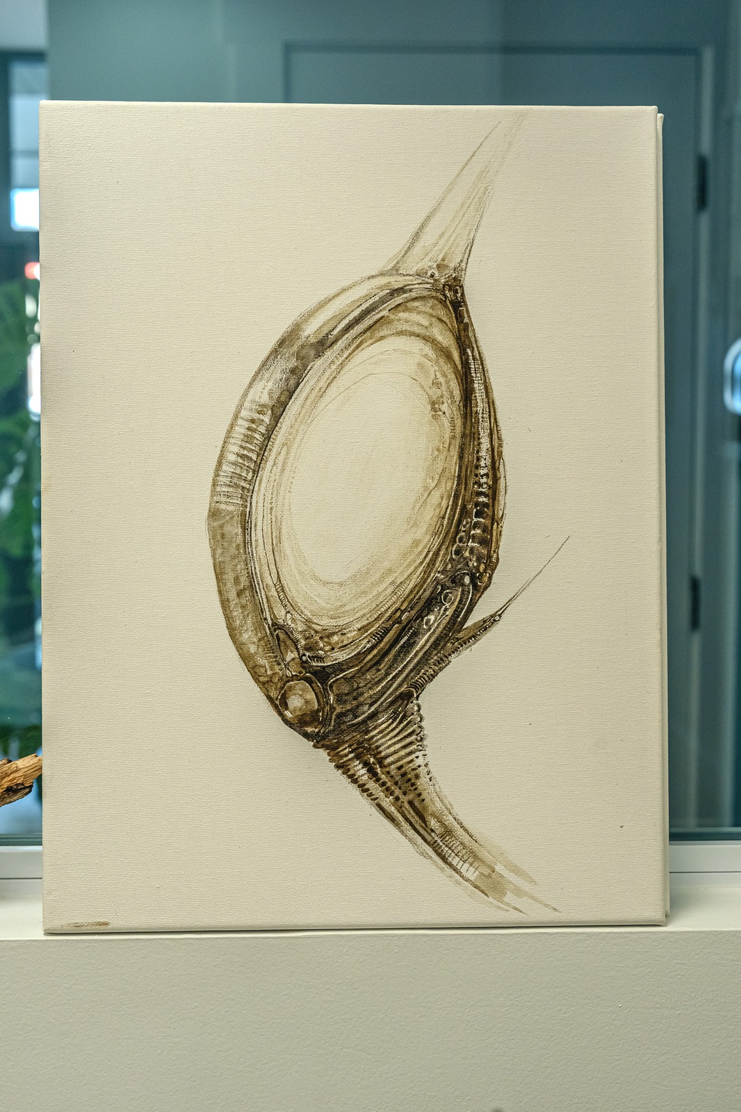 A painting of a creature with metallic textures and sharp points on a canvas.