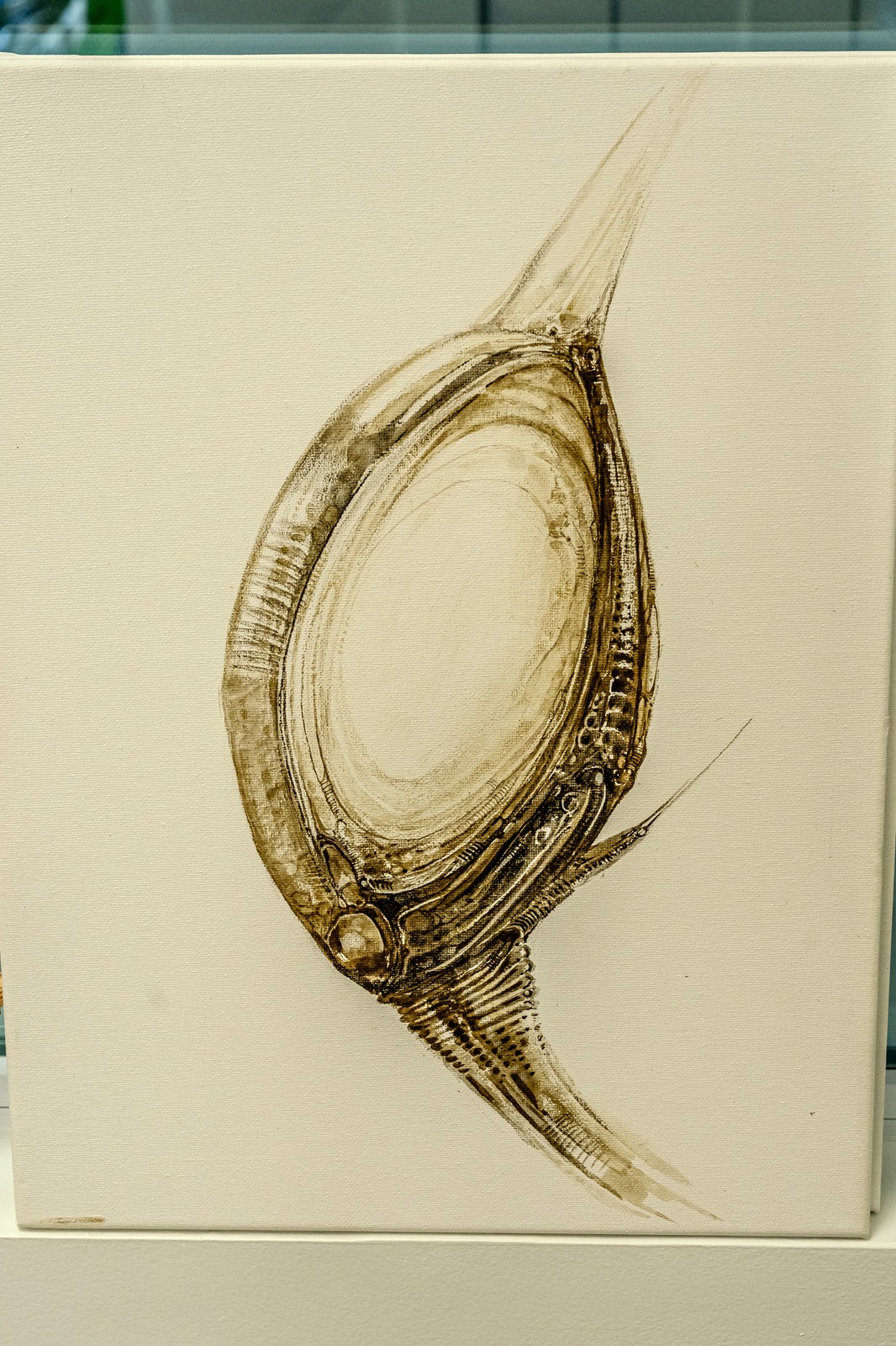 A painting of a biomechanical creature on a canvas.
