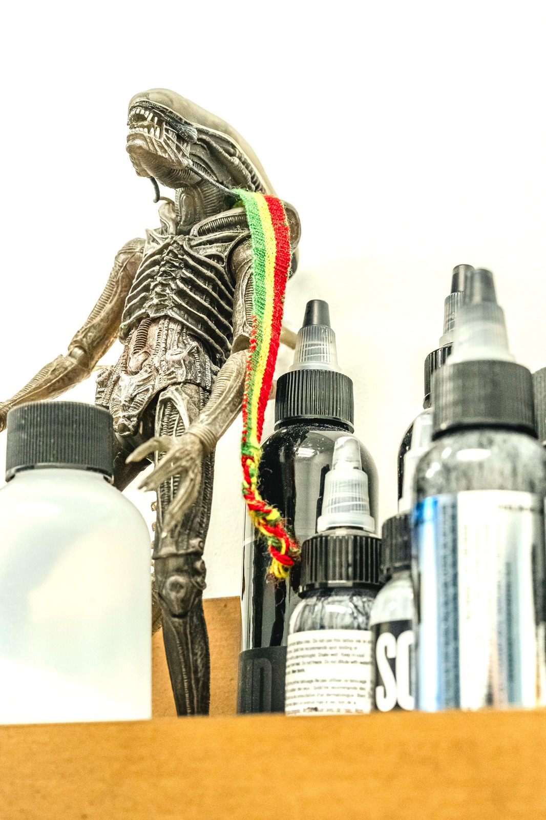 A figurine stands with its arms outstretched.