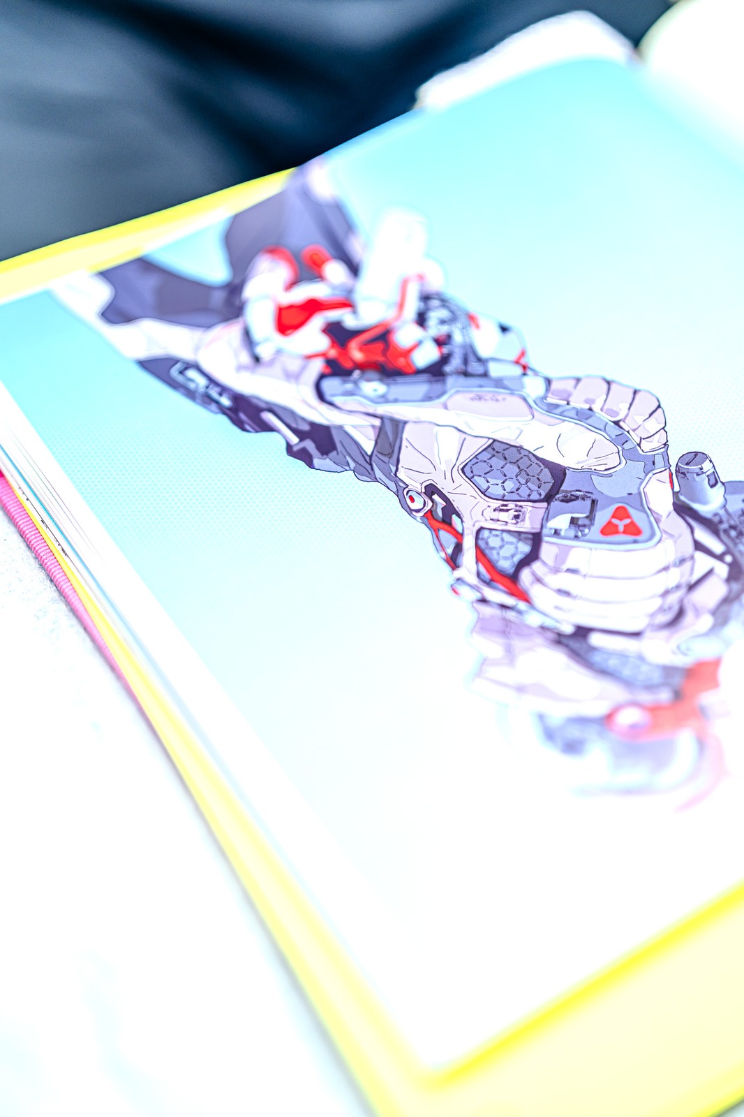 A book displays a colorful illustration of a robot character.